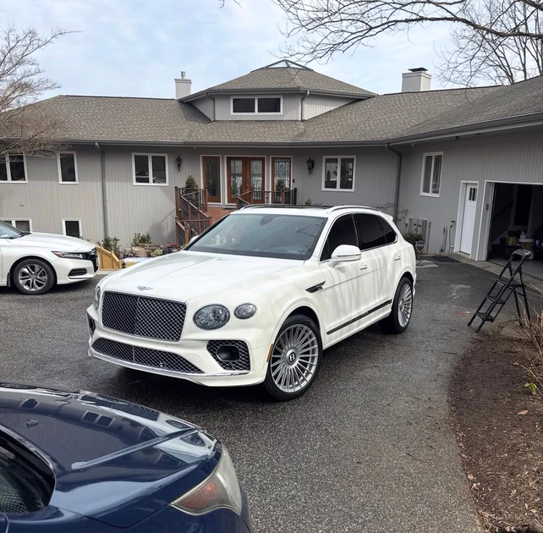 White Bentley Bentayga detailed on a residential driveway