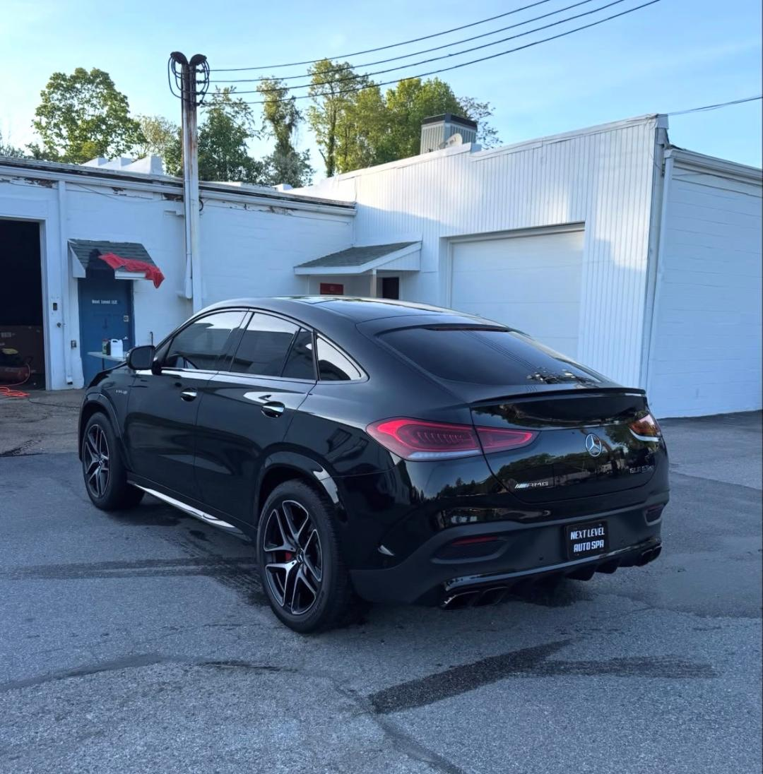 Rear of a detailed black AMG GLE Coupe with polished paint